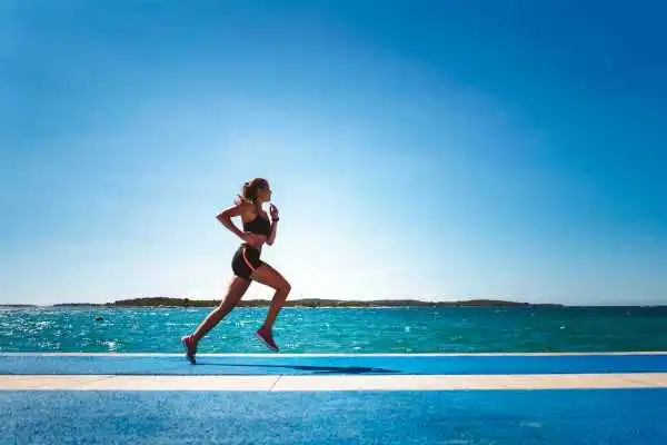 Woman running showing strong leg muscle Glossop
